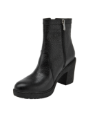 Botín negro de cuero para mujer, estilo casual, ideal para el invierno por su protección contra frío y humedad.