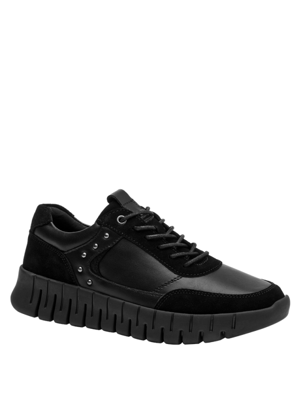 Zapatilla casual negra de mujer, combinando materiales suaves y gamuza, perfecta para uso cotidiano e informal.