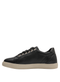 Elegante zapatilla negra de cuero para mujer con textura granulada en la capellada, aportando un toque moderno al diseño.