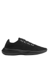 Zapatilla moderna negra para hombre, con exterior textil y suela resistente, perfecta para climas cálidos y uso diario.
