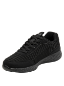 zapatilla de mujer negra con suela salpicada en blanco/gris, perfecta para un estilo casual y moderno.