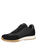 Zapatilla negra deportiva de mujer con diseño minimalista y detalles en suela café claro.